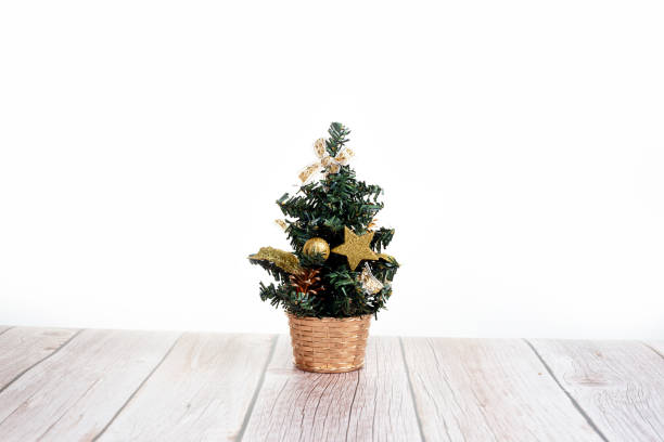 istock Cute little Christmas tree on wooden table 1338721803