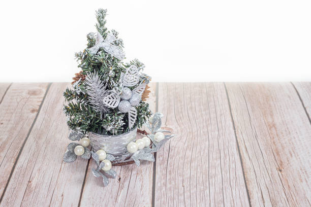 istock Cute little Christmas tree on wooden table 1338721818