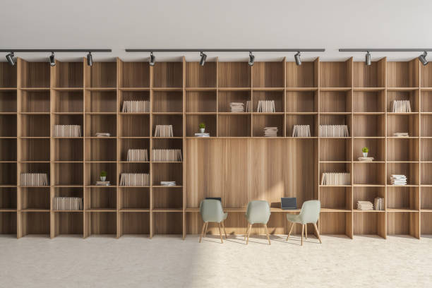 istock Office wall with beige and green details and floor-to-ceiling shelving 1338722016
