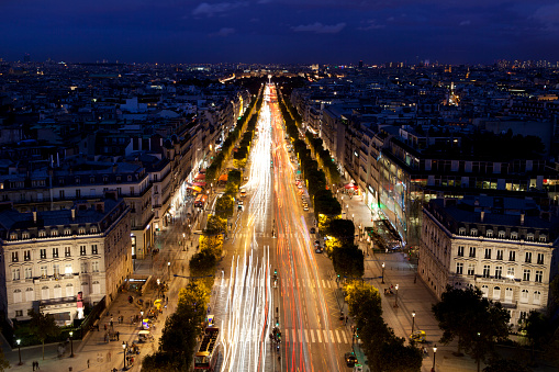 Light trails at night on Champs Elysee in Paris, France.