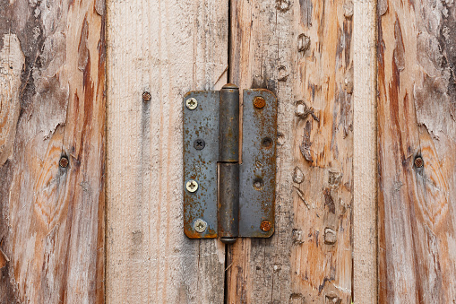 rusty metal door hinge. Door hinge on a wooden wall.