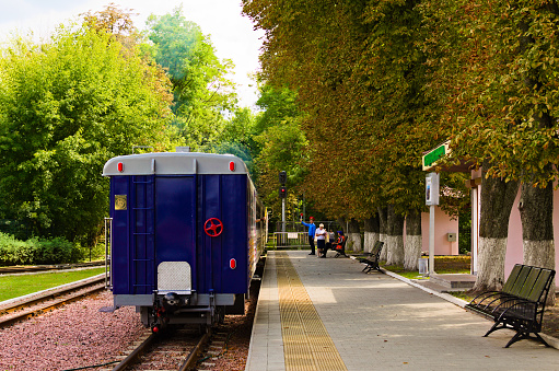 Kyiv, Ukraine-August 22, 2021:Children’s train departs from a station. The stationmaster allowed the departure. Railway station of Kyiv Children's Railway in Syretsky Park. Train departure is allowed.