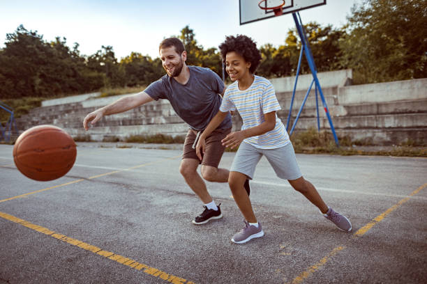 istock Father and his daughter playing basketball 1338726199