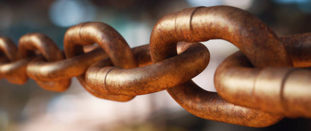 istock Extreme close up on a completely rusty chain on a highly defocused background. Wide horizontal composition. 1338726412