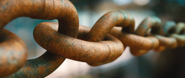 istock Extreme close up on a very rusty heavy chain on a highly defocused dark background. Wide horizontal composition. 1338726494