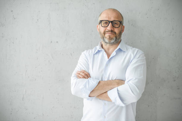 istock mature adult man ( gray background) 1338727612