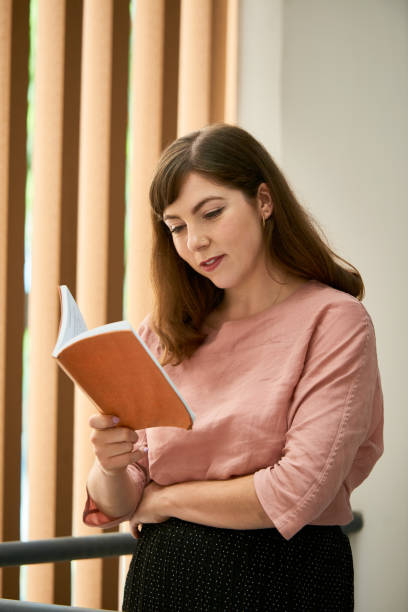 istock Woman Reading Captivating Book 1338727998