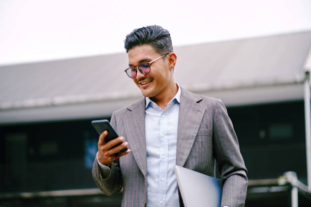 Senior Executive Man Talking on The Phone While Walking at Corporate Offices