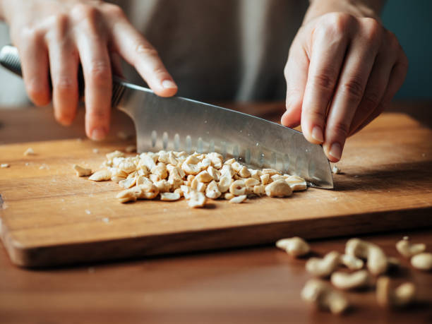 Female hands chopping cashew