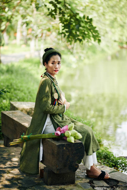 istock Beautiful Woman Sitting on Bench 1338731022