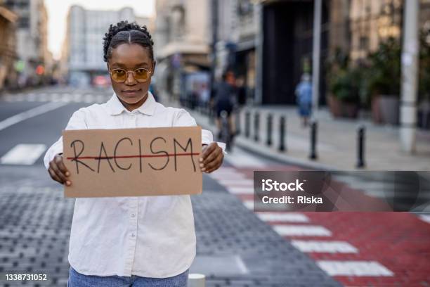 Young Woman Protesting On The Street Against Racism Stock Photo - Download Image Now