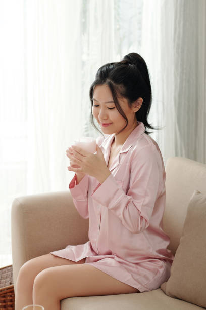 istock Woman Smelling Moisturizing Lotion 1338731939