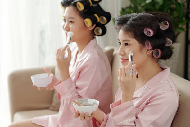 istock Young Women Applying Charcoal Face Mask 1338731977
