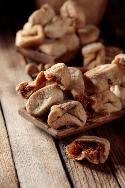 istock Dried figs on a old wooden table. 1338734974