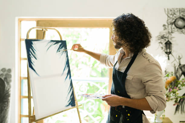 istock Hispanic artist creating a new art piece 1338735379
