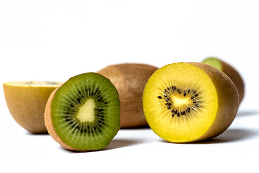 photo of tropical kiwi fresh slices sliced on black background with water drops
