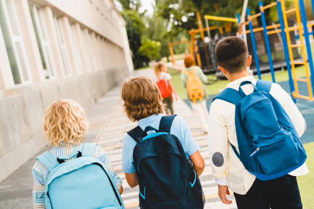 istock Schoolchildren classmates kids pupils students going together from school home after classes lessons. Education, learning, new academic semester year 1338738809