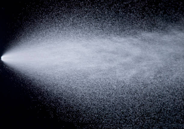 A white-colored jet spraying against deep black badkground.