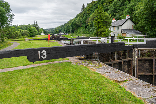 Lock number 13 on the Crinan Canal with a derelict lock keepers house in the background
