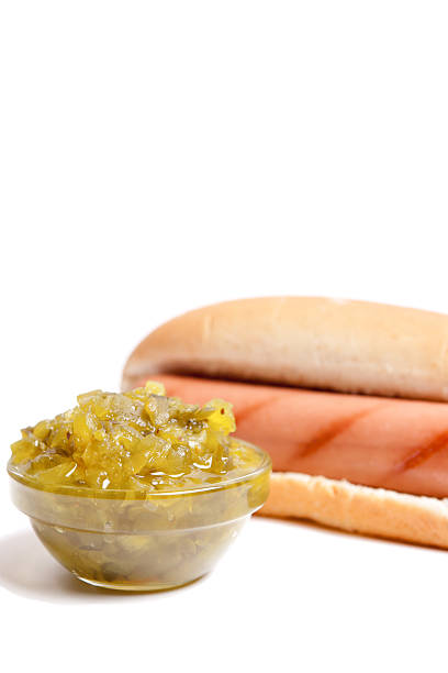 Hot Dog with Pickle Relish Plain hot dog with side of pickle relish.  Isolated on white. relish stock pictures, royalty-free photos & images