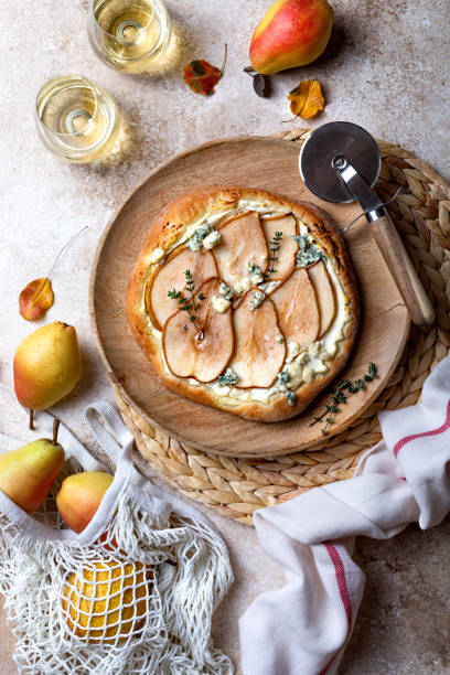 istock Pizza with pear, thyme, ricotta and blue cheese on  wooden board 1338744493