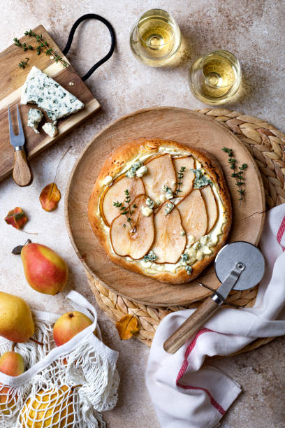 istock Pizza with pear, thyme, ricotta and blue cheese on  wooden board 1338744597