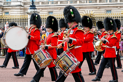 London, England - August 2021: Drummers of the Welsh Guards regimental band playing as they march from Buckingham Palace after the Changing of the Guard ceremony