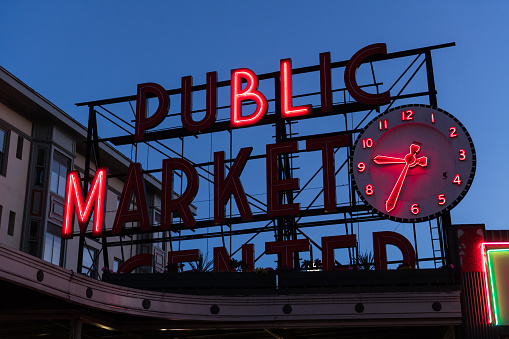 Seattle, USA - Jun 19th, 2021: Twilight at the Pike Place Market sign illuminated on Juneteenth.
