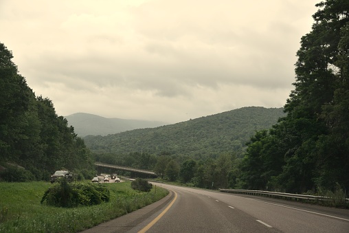 A morning drive in Vermont, the really, really Green Mountain State, on I-89 with the sun trying to burn through the overcast sky