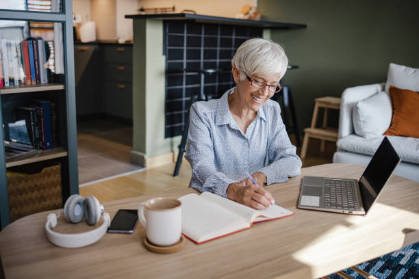 istock Senior woman working on laptop at home 1338746961