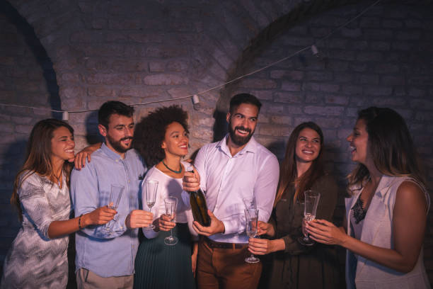 istock Friends opening champagne at New Year's midnight countdown 1338747298