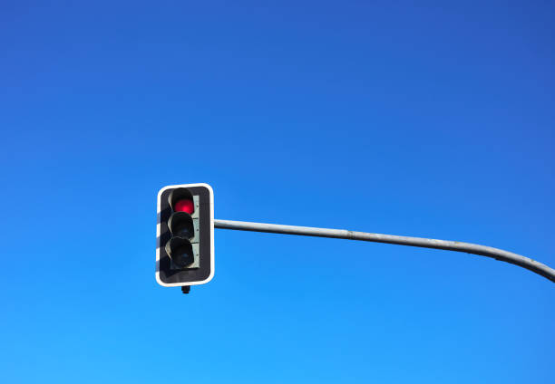 istock traffic light with red light on with blue sky in the background 1338747997