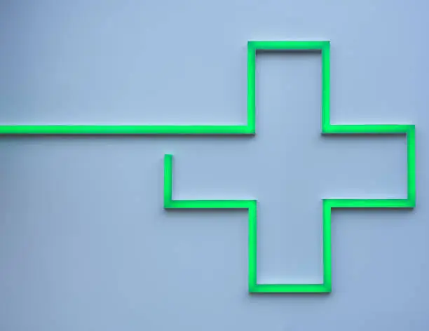 Photo of green led cross on a pharmacy wall