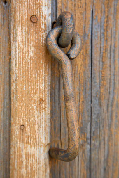 istock Old metal hook for a wooden barn door 1338750161