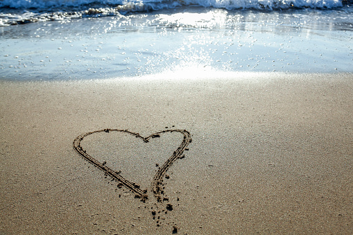 Heart symbol in the sand by the Sea