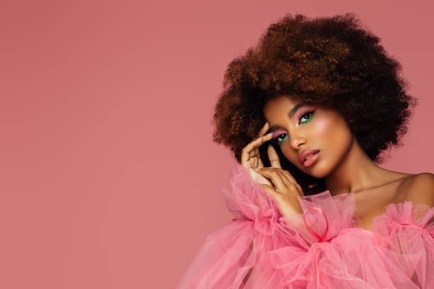Beautiful afro woman with bright make-up Beautiful afro woman with bright make-up pink gown stock pictures, royalty-free photos & images