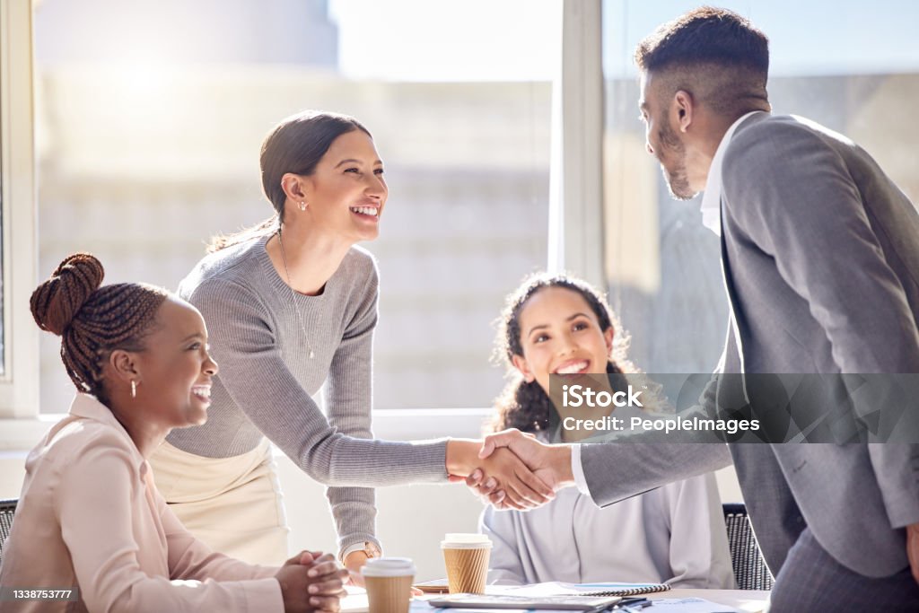 Shot of two businesspeople shaking hands during a meeting in an office This opportunity is one we've been anticipating Business Stock Photo