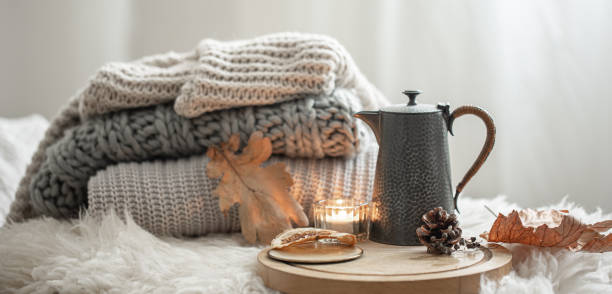 istock Cozy autumn composition with a stack of knitted sweaters and tea. 1338755840