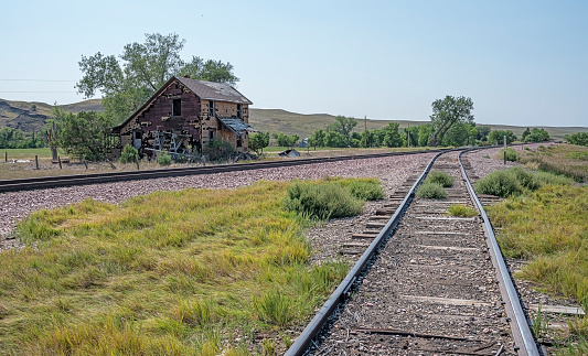 Railroad track and abandoned building in the ghost town of Owanka, South Dakota, USA