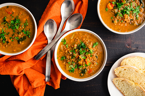 Vegetable and lentil soup with fresh herbs served with fresh bread