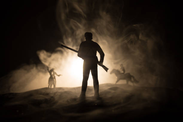 istock Western cowboy silhouette with texture at sunset and slivers of light 1338761528