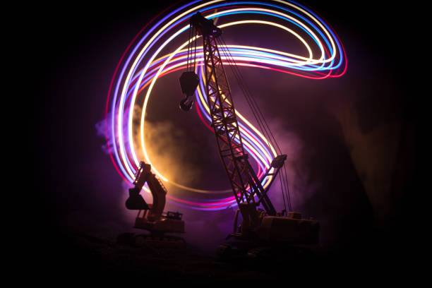 istock Abstract Industrial background with construction crane silhouette over amazing night sky with fog and backlight. Tower crane against the foggy sky at night. 1338761543