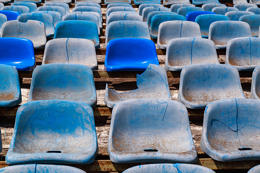 Destroyed stadium stands. Broken fan chairs. Selective focus