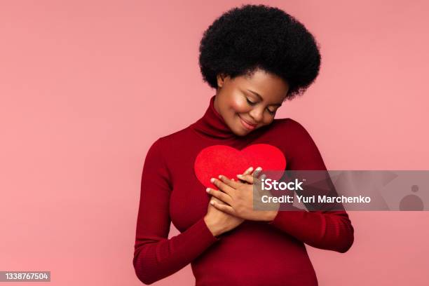 Happy African Woman Embracing Red Heart Shaped Postcard From Lover Or Boyfriend On Valentines Day Stock Photo - Download Image Now