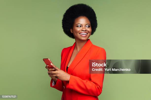 Successful African Businesswoman With Smartphone Look Aside With Confident Happy Smile Isolated Stock Photo - Download Image Now