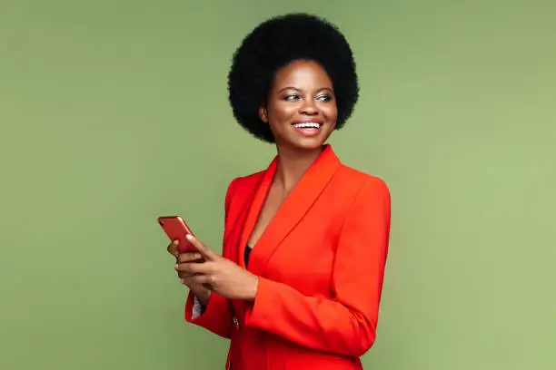 Photo of Successful african businesswoman with smartphone look aside with confident happy smile isolated