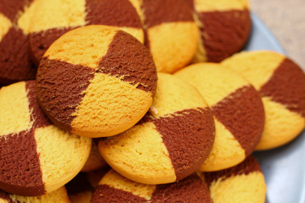 Two-color cookies in a plate close-up, background