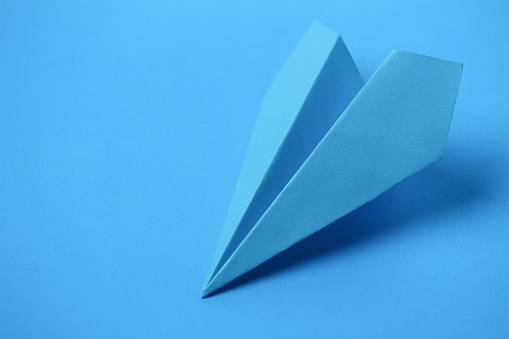 Paper blue airplane on a blue background