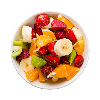 fruit salad with banana, strawberry, orange and kiwi isolated on white background top view