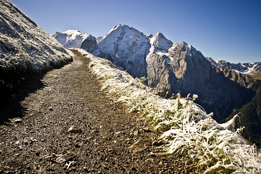 Country road in winter. Location: Italian Alps, Dolomites, Mt Marmolada.
